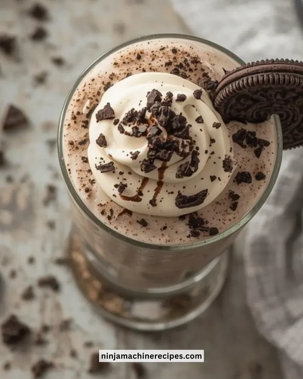 Delicious Cookies and Cream Slush served in a clear cup with whipped cream and cookie crumbles