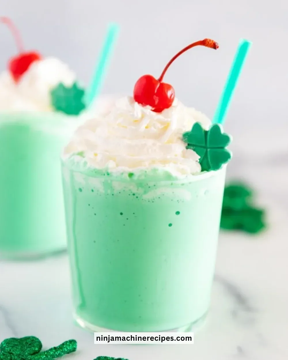A delicious copycat Shamrock Shake in a green cup with whipped cream on top.