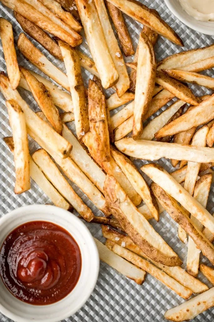 Crispy air fryer french fries served in a bowl with dipping sauces