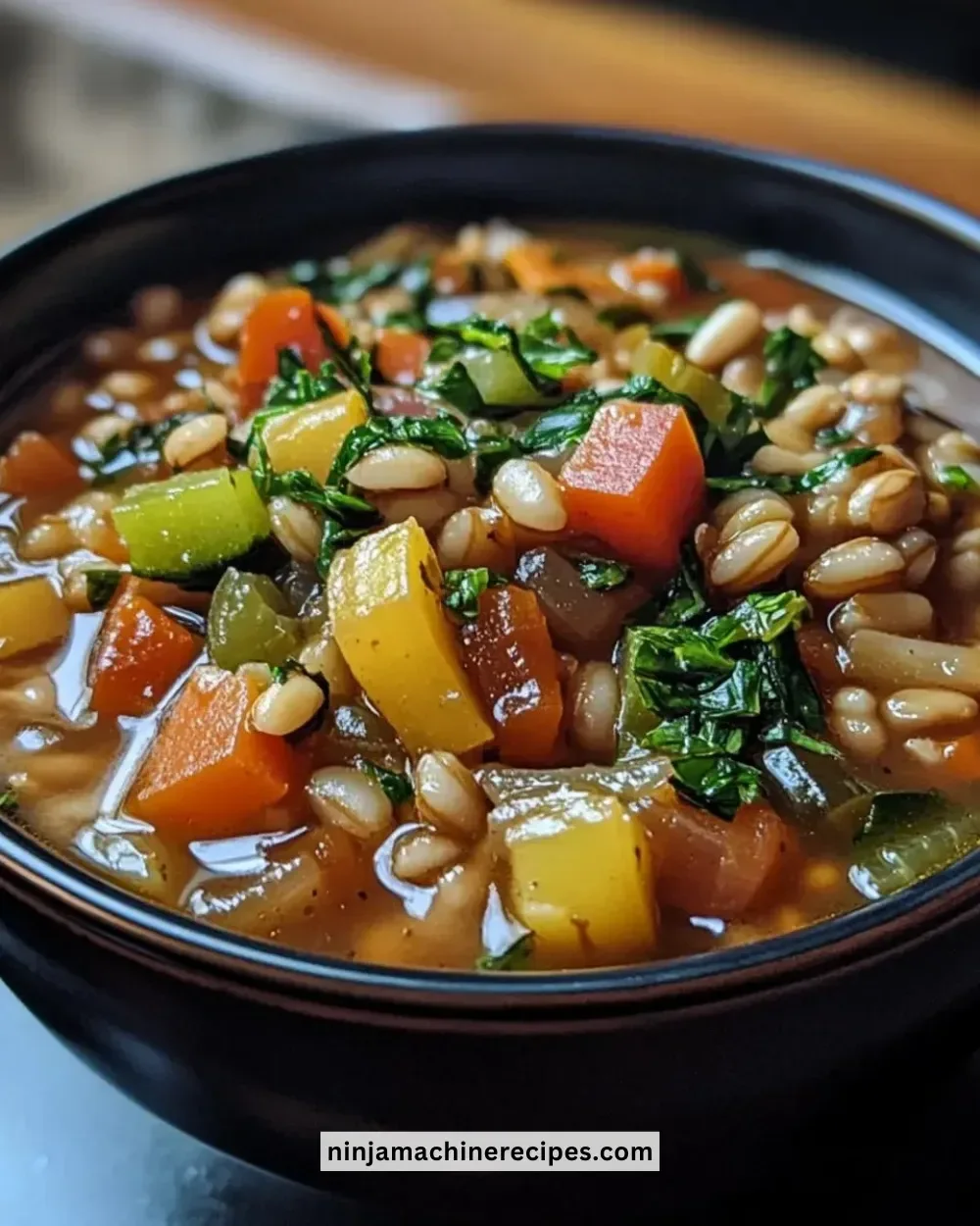 Bowl of easy Crockpot Veggie Barley Stew with fresh vegetables and barley