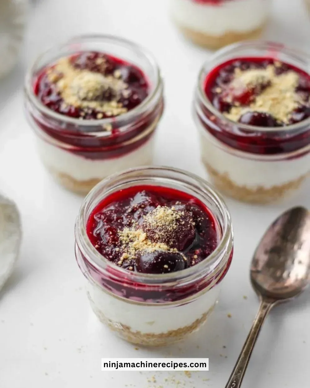 Healthy no-bake cheesecake in a jar with fresh fruits and cream