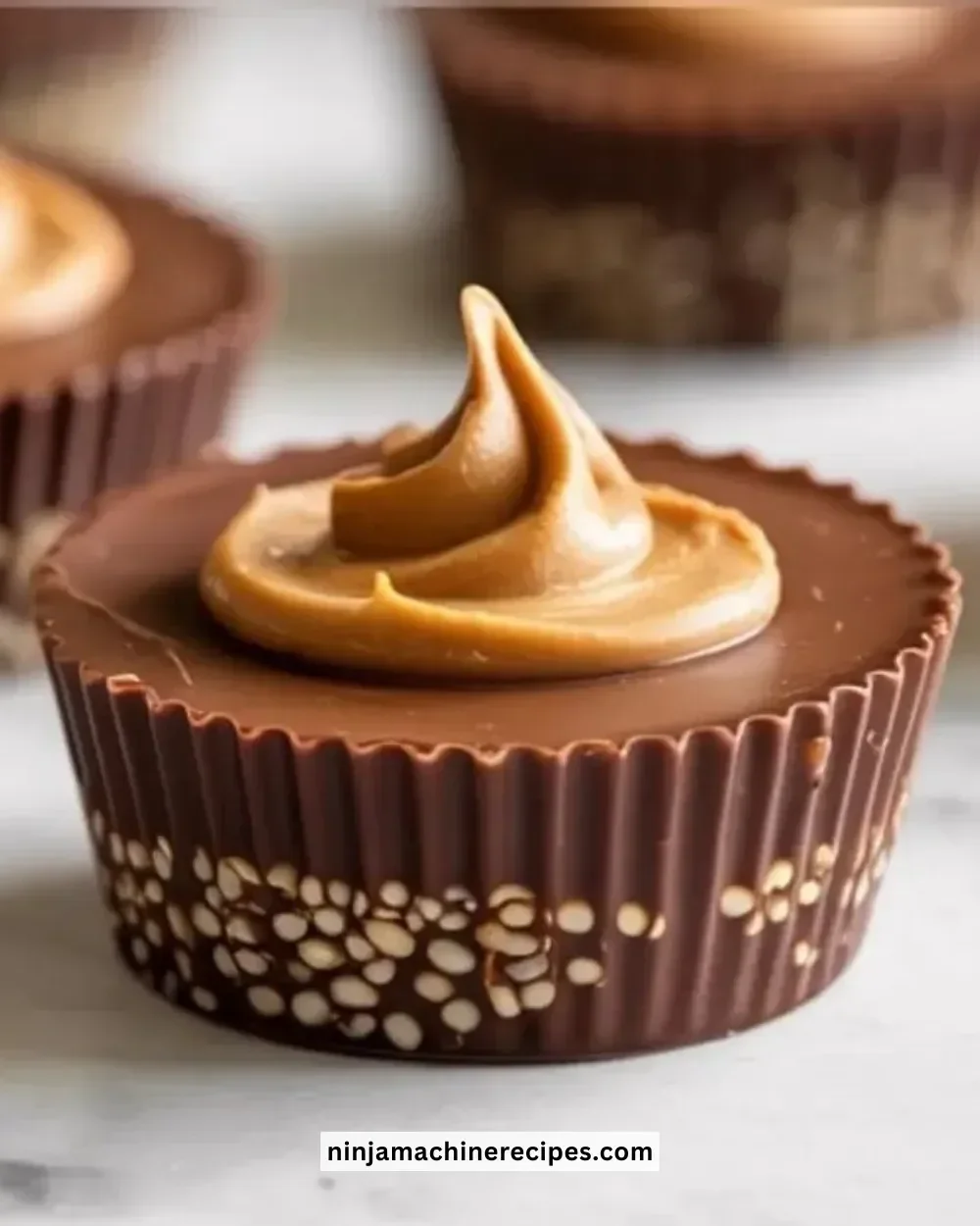 Healthy quinoa peanut butter cups filled with creamy peanut butter and topped with chocolate