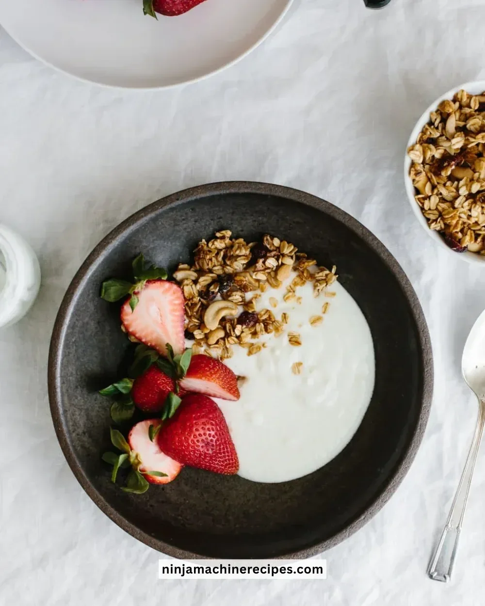 Bowl of creamy homemade yogurt with fresh fruits and honey on top