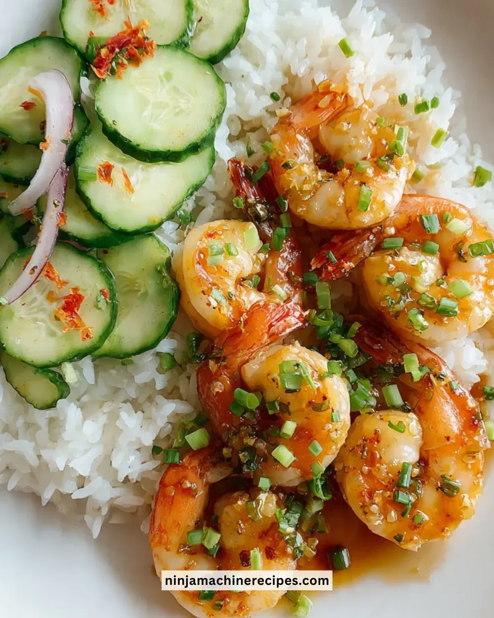 Plate of Honey Garlic Shrimp garnished with green onions and sesame seeds
