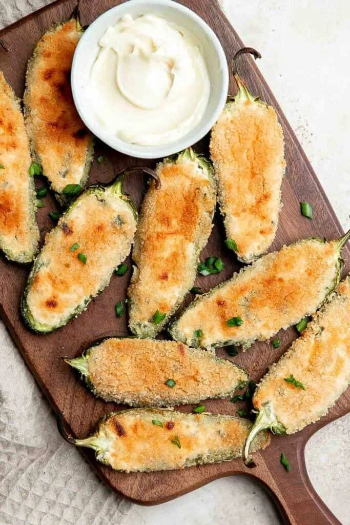 Plate of spicy jalapeño poppers filled with cheese and herbs