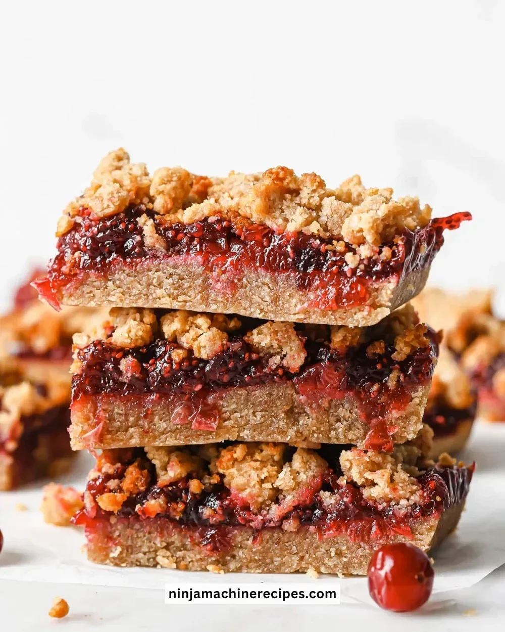 Homemade Keto Cranberry Bars topped with nuts and berries