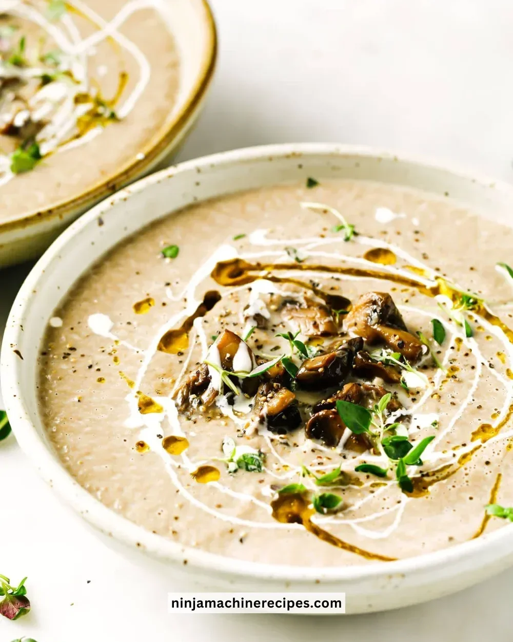 Delicious bowl of creamy Keto Mushroom Soup garnished with herbs