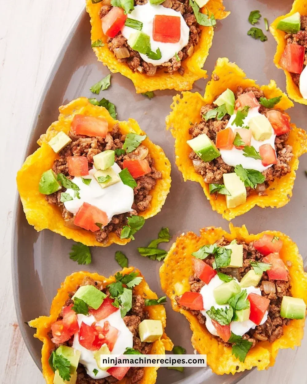 Delicious Keto Taco Cups served on a plate with toppings.