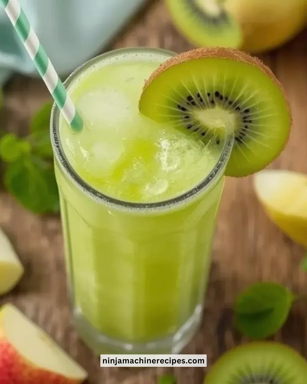 A refreshing Kiwi Apple Slushie served in a glass with kiwi and apple slices.