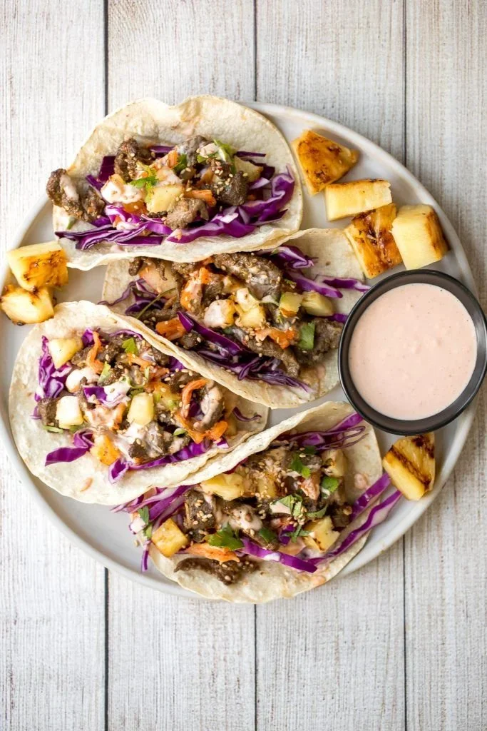 Delicious Korean beef steak tacos topped with fresh ingredients.