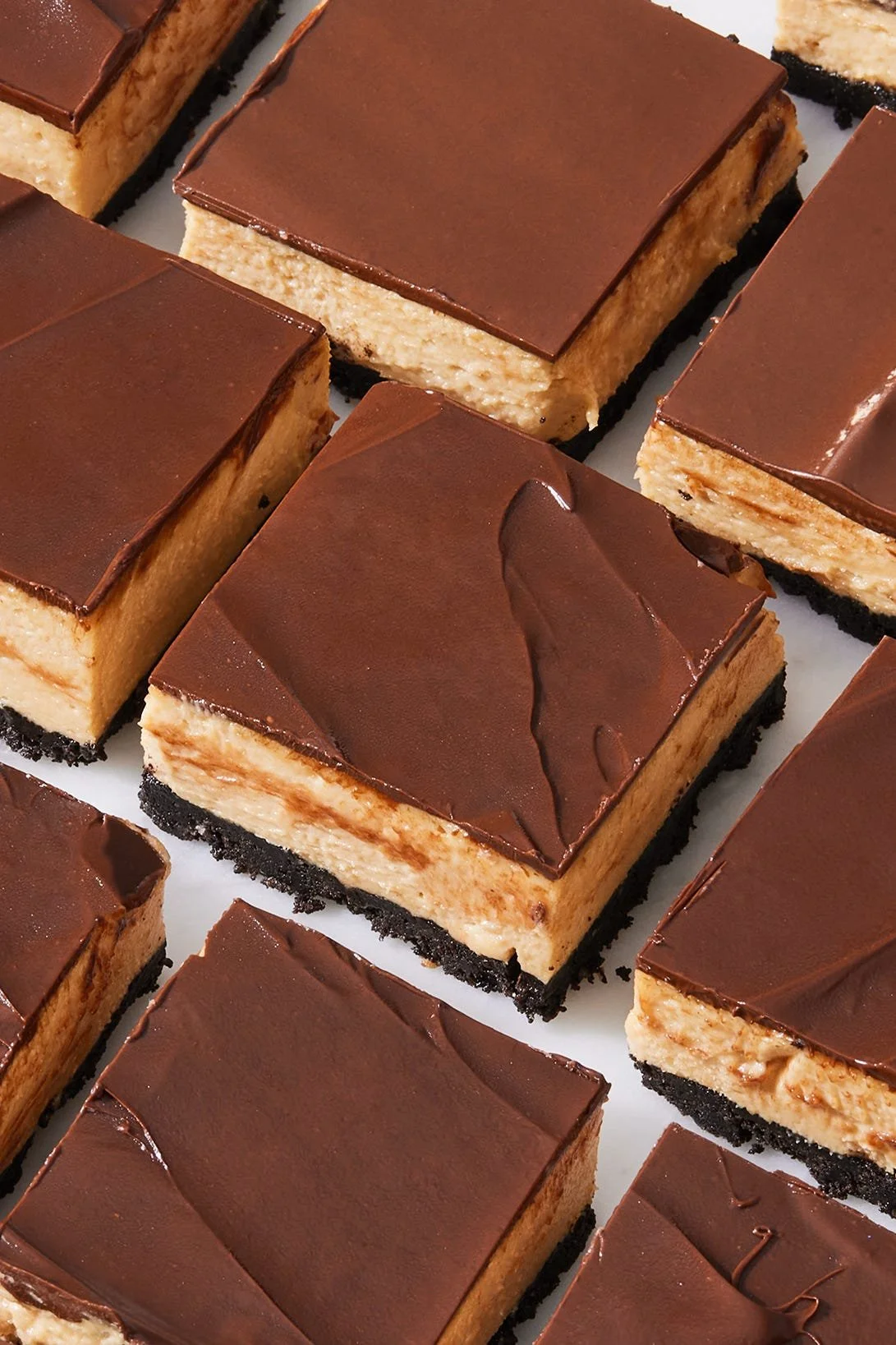 No-Bake Buckeye Cheesecake Bars topped with chocolate and peanut butter icing.