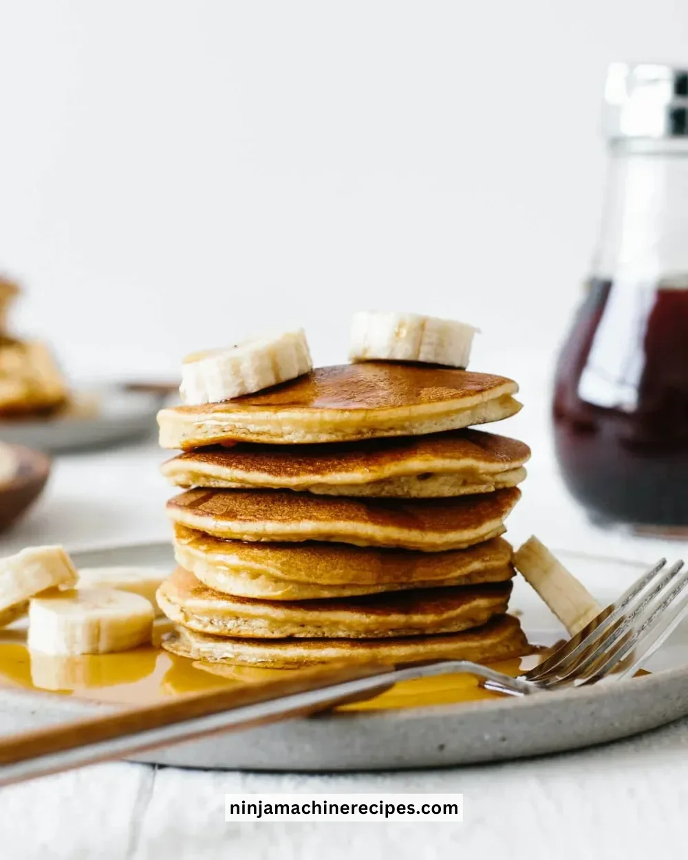 Stack of fluffy Paleo pancakes on a plate with fresh berries