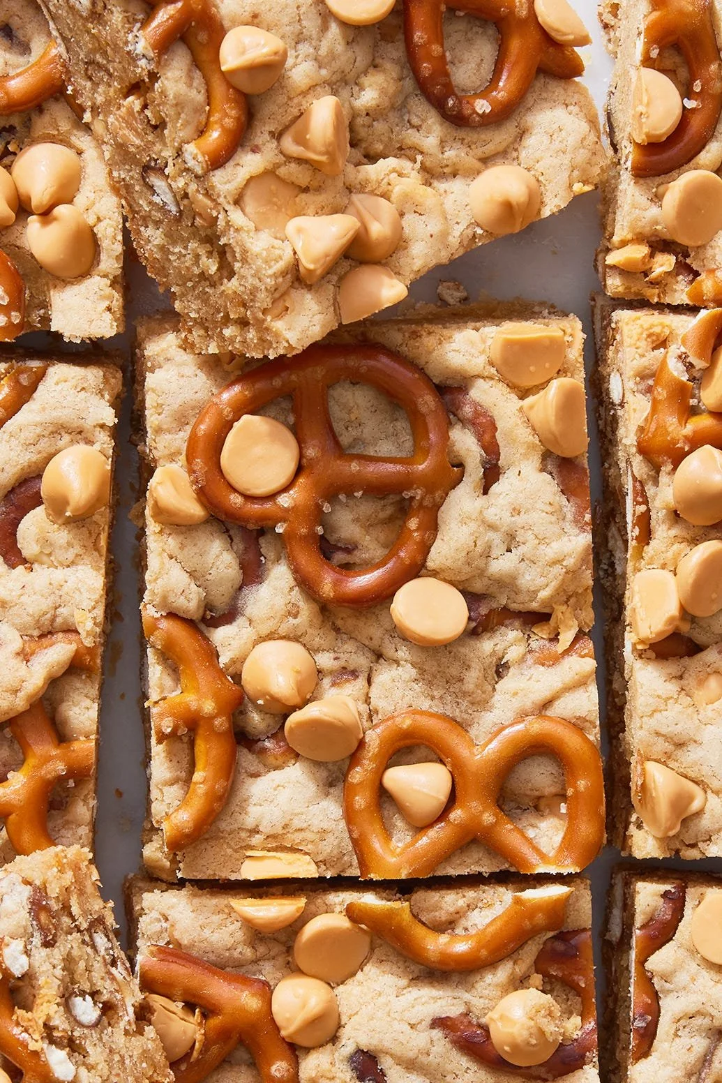 Peanut butter pretzel butterscotch blondies on a plate with a fork