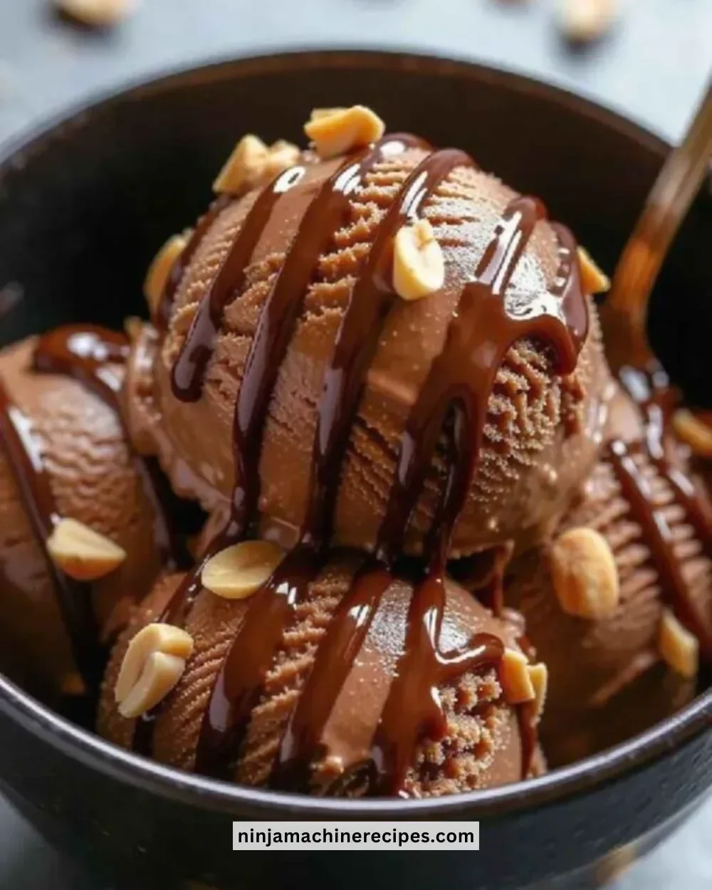 Bowl of protein-packed chocolate peanut butter ice cream topped with nuts