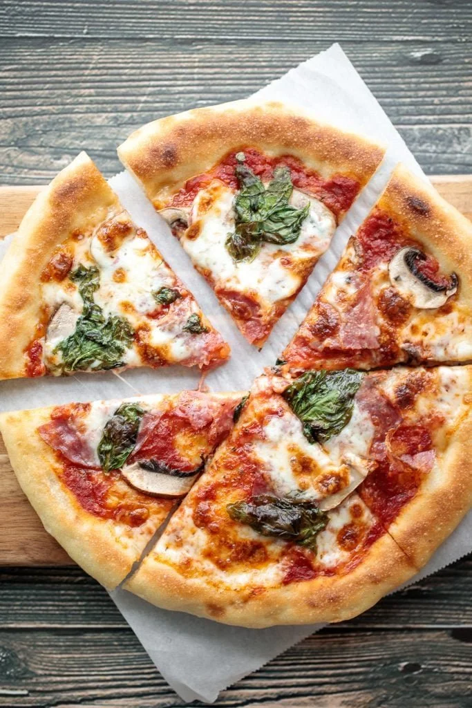 Salami and mushroom skillet pizza topped with herbs and cheese