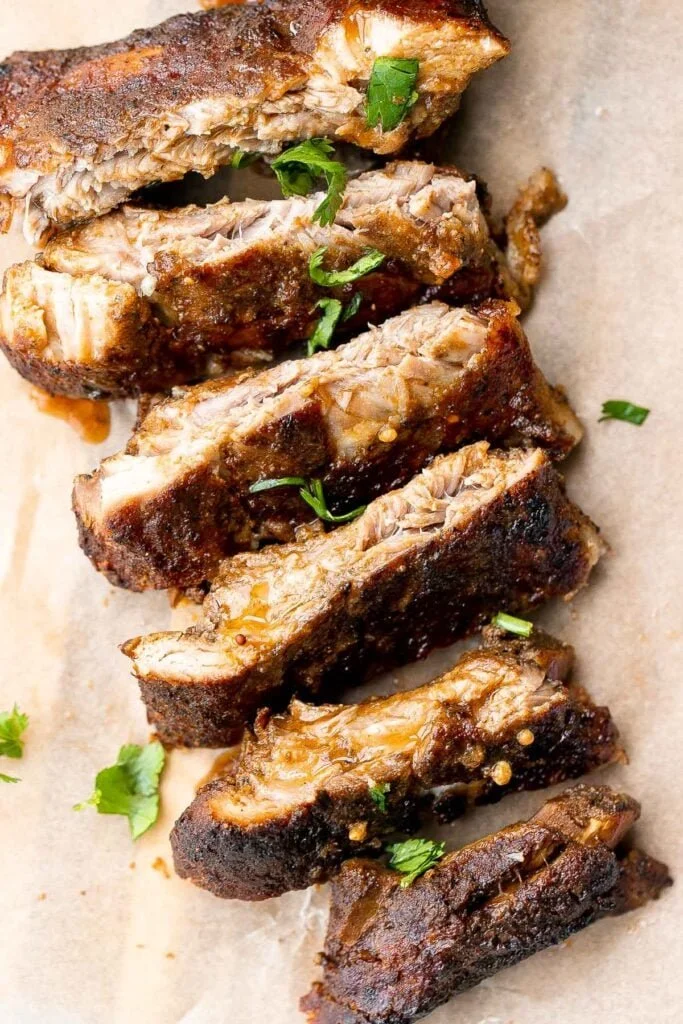 Slow Cooker BBQ Ribs served on a plate with barbecue sauce and sides