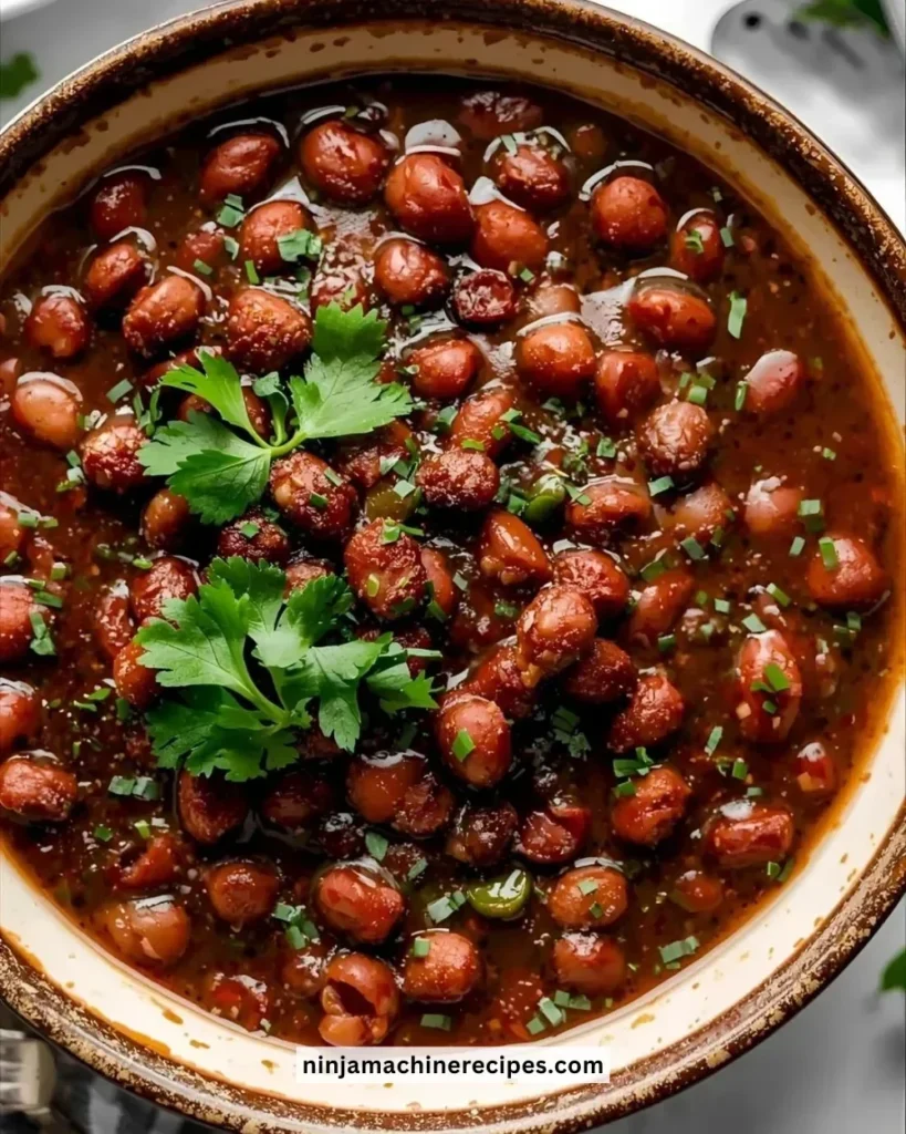 Bowl of slow cooker black eyed peas garnished with herbs