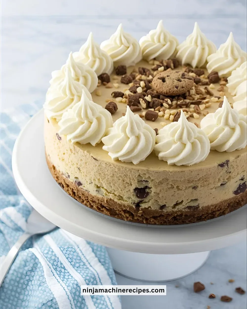 Delicious sugar cookie cheesecake topped with whipped cream and colorful sprinkles