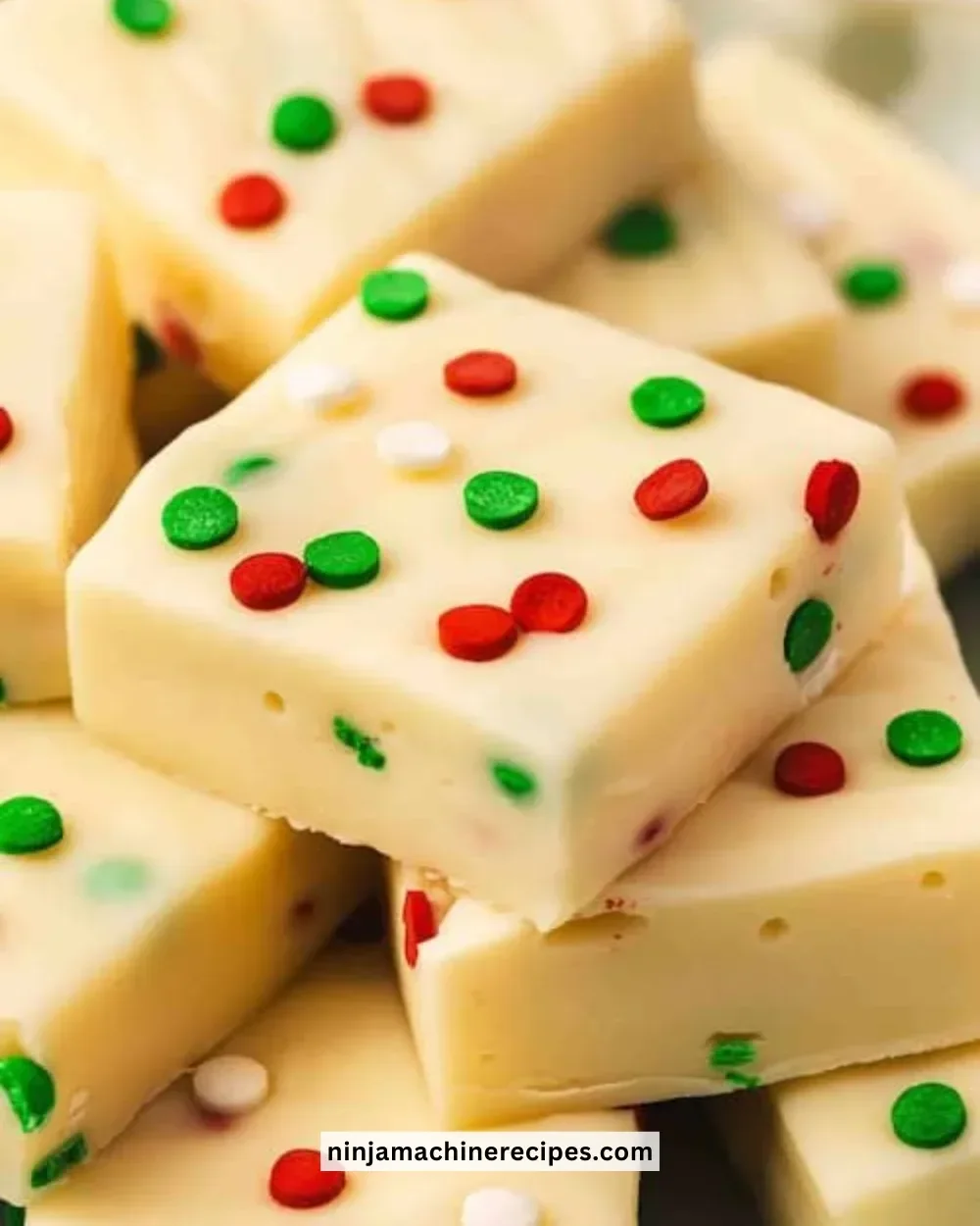 Deliciously colorful sugar cookie fudge pieces on a plate.