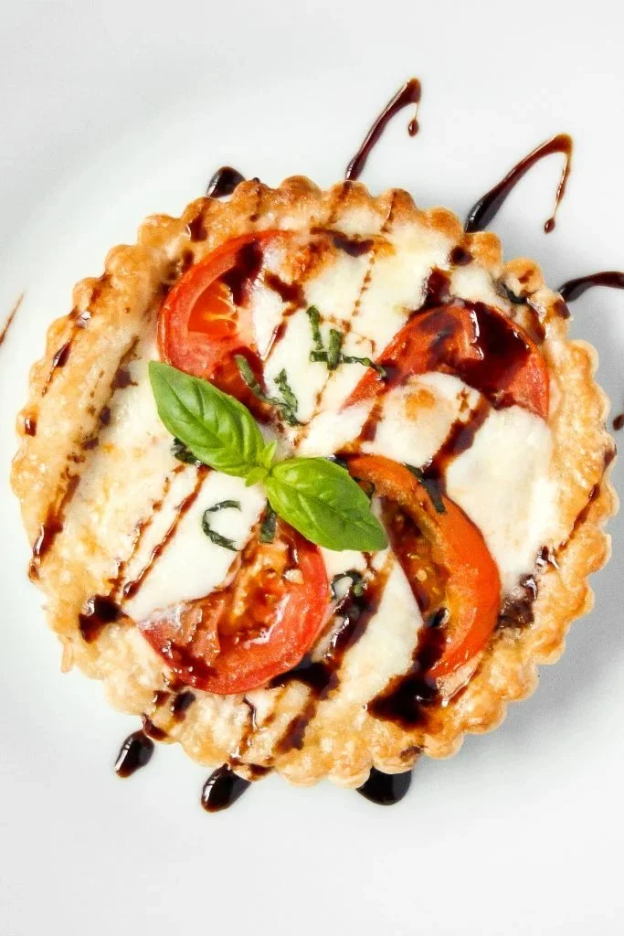 Delicious Tomato Mozzarella Tart with fresh basil and a flaky crust