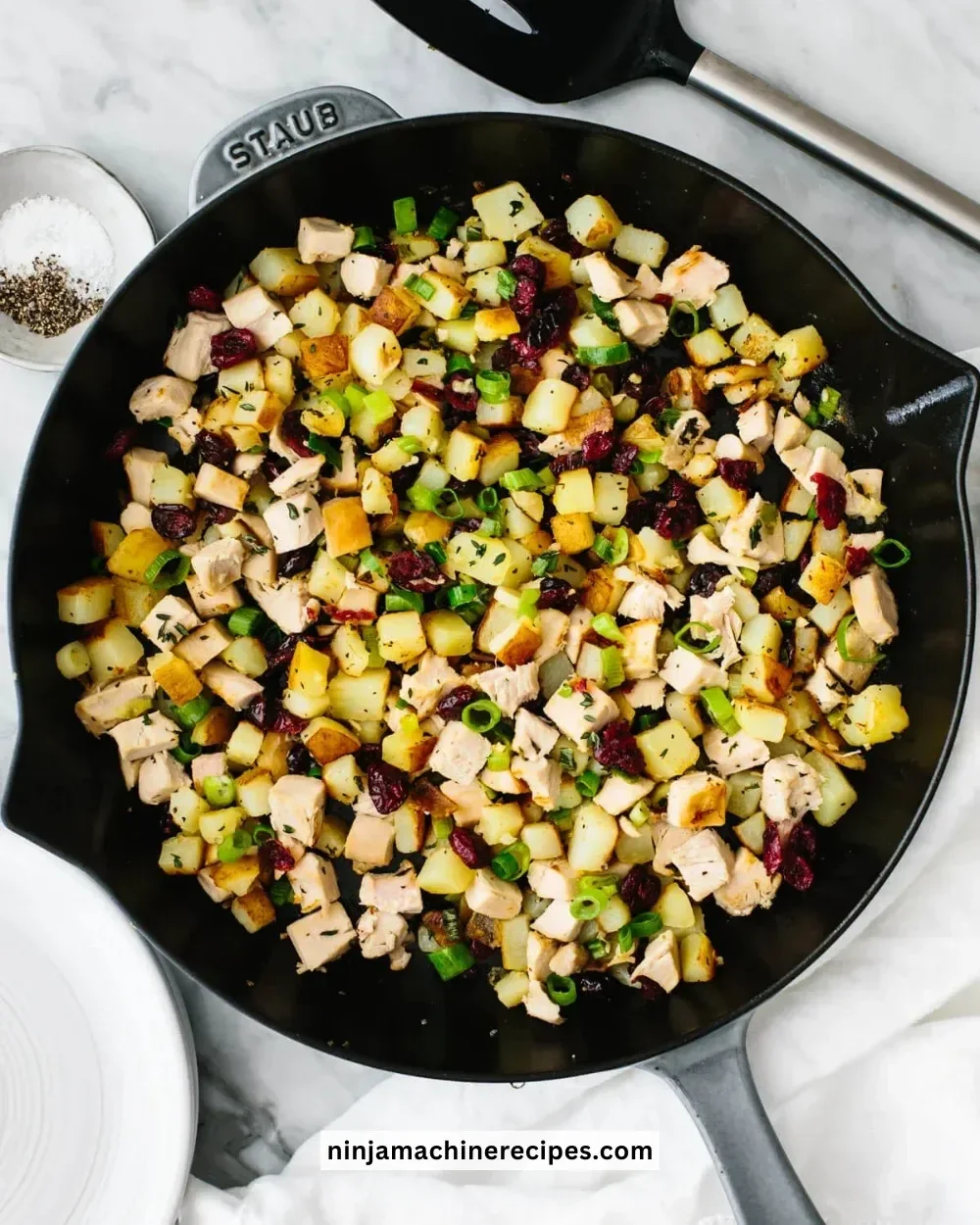 Plate of Turkey Cranberry Hash with cranberries and herbs