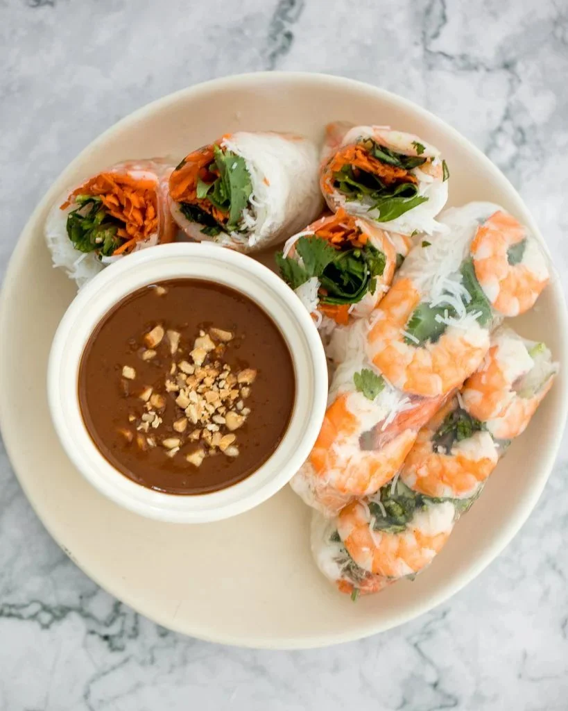 Vietnamese salad rolls served with peanut dipping sauce on a plate