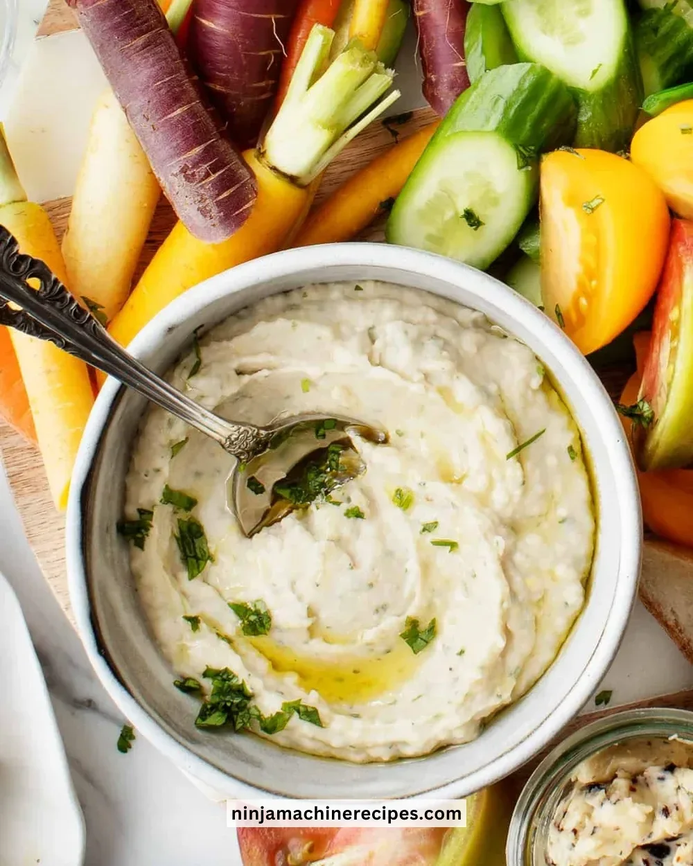 Delicious white bean dip served with fresh vegetables and tortilla chips