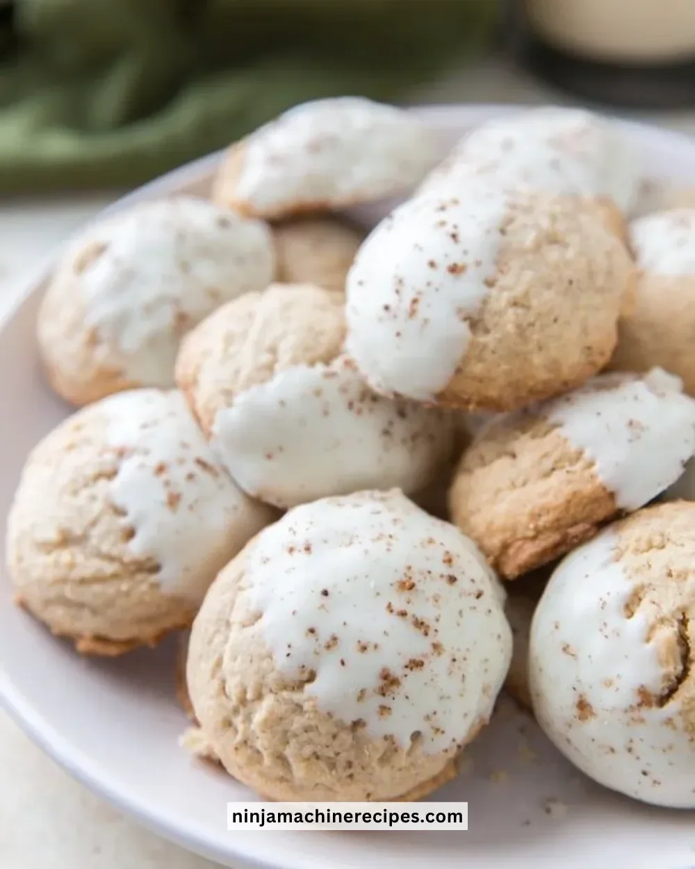 Delicious white chocolate dipped eggnog cookies arranged on a festive platter