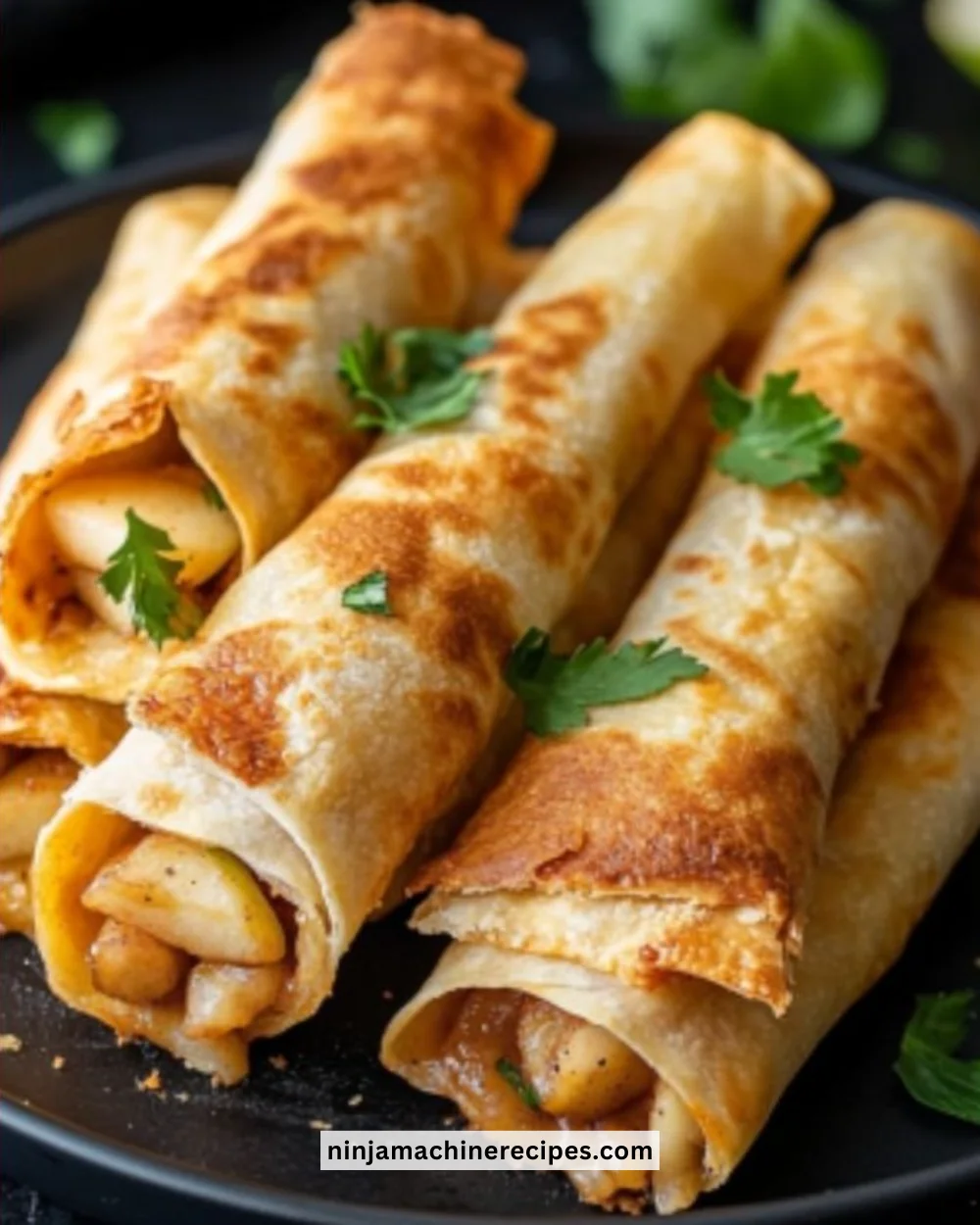 Apple pie taquitos served on a plate with caramel drizzle.
