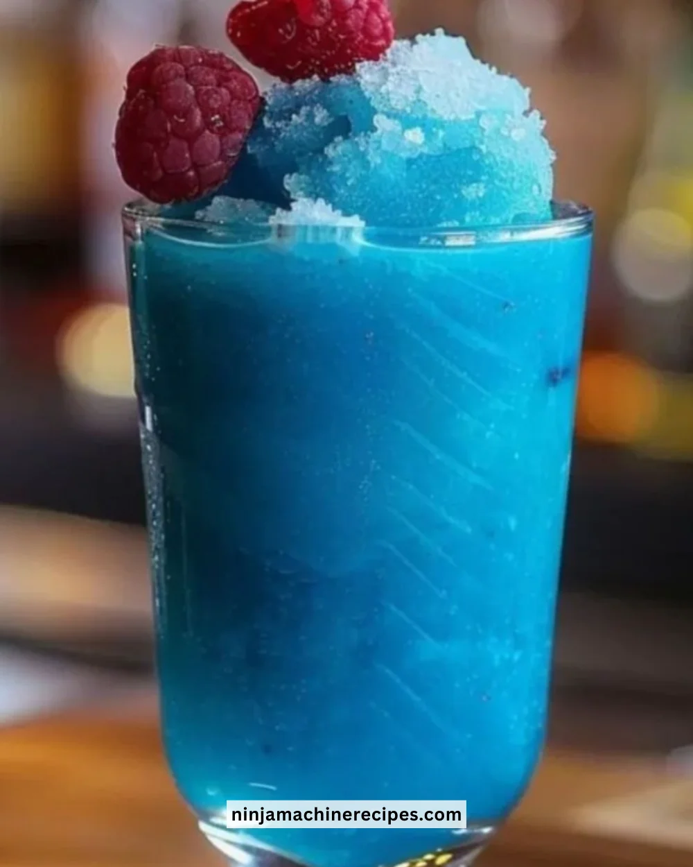 Refreshing blue raspberry lemonade slushie in a glass with ice