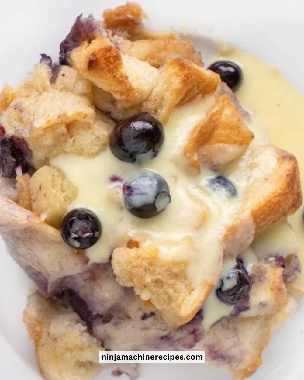 Delicious blueberry bread pudding drizzled with creamy anglaise sauce