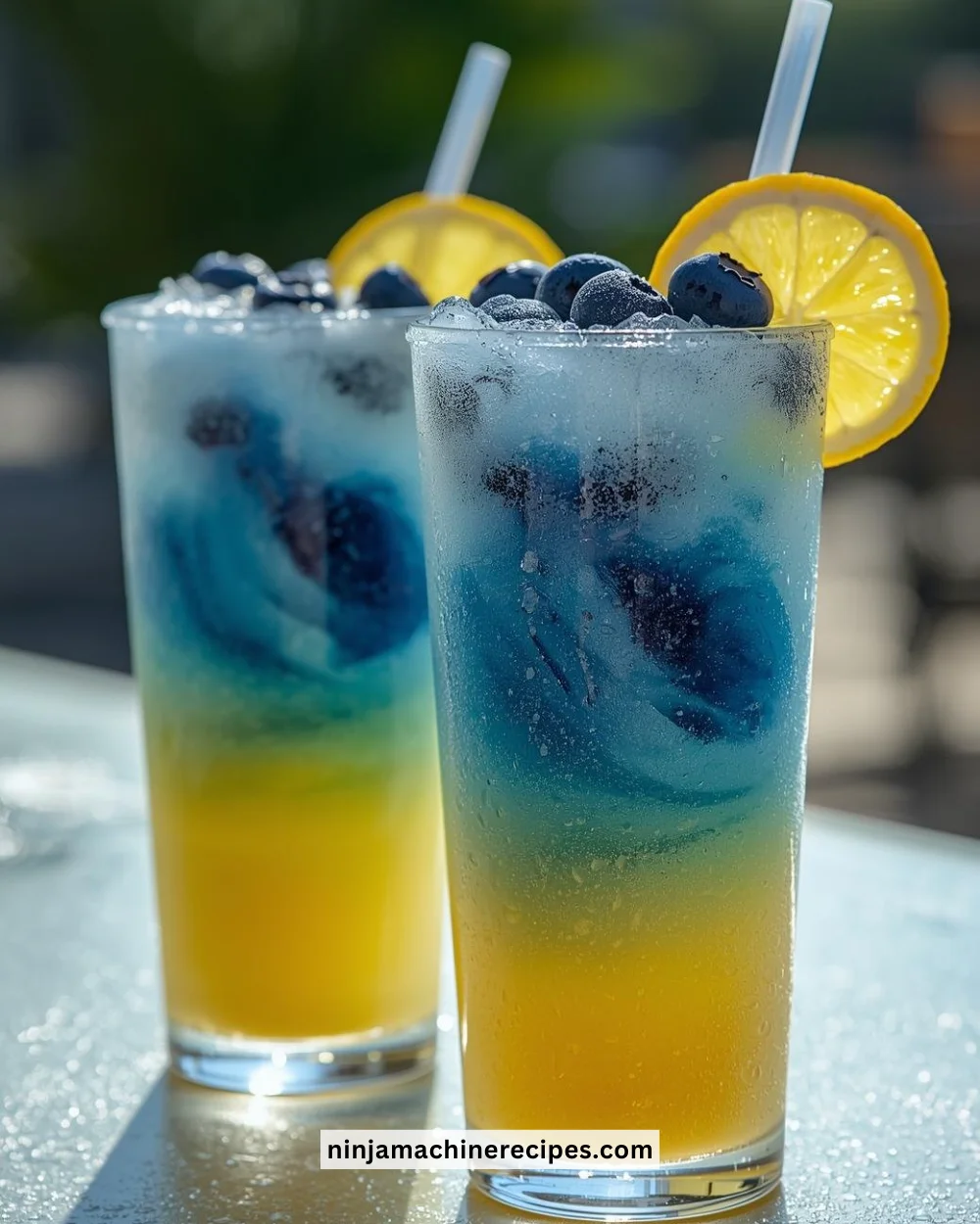 Refreshing Blueberry Lemon Drop Slushies in a glass with blueberries and lemon slices.