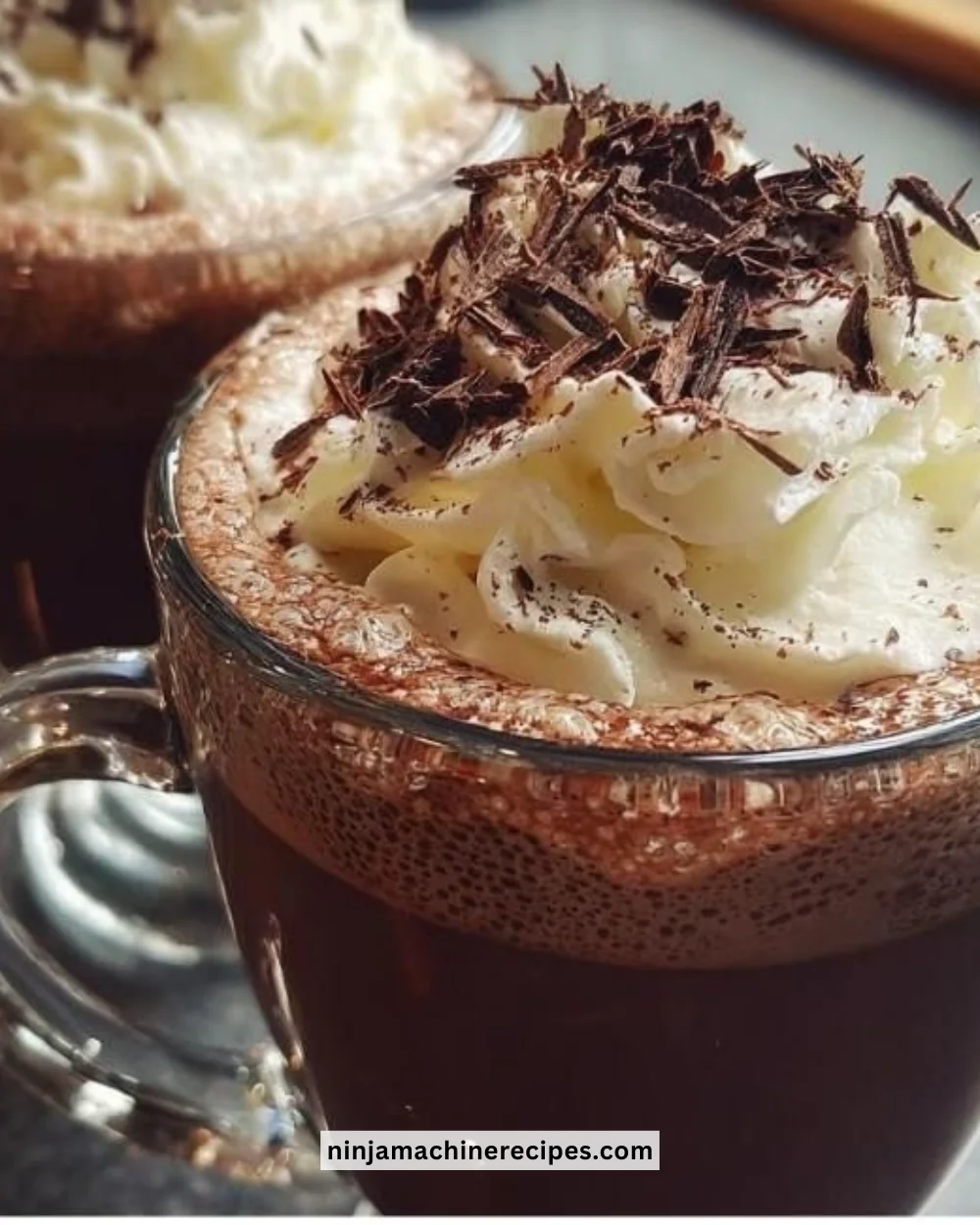 Indulgent boozy hot chocolate topped with whipped cream and chocolate shavings.