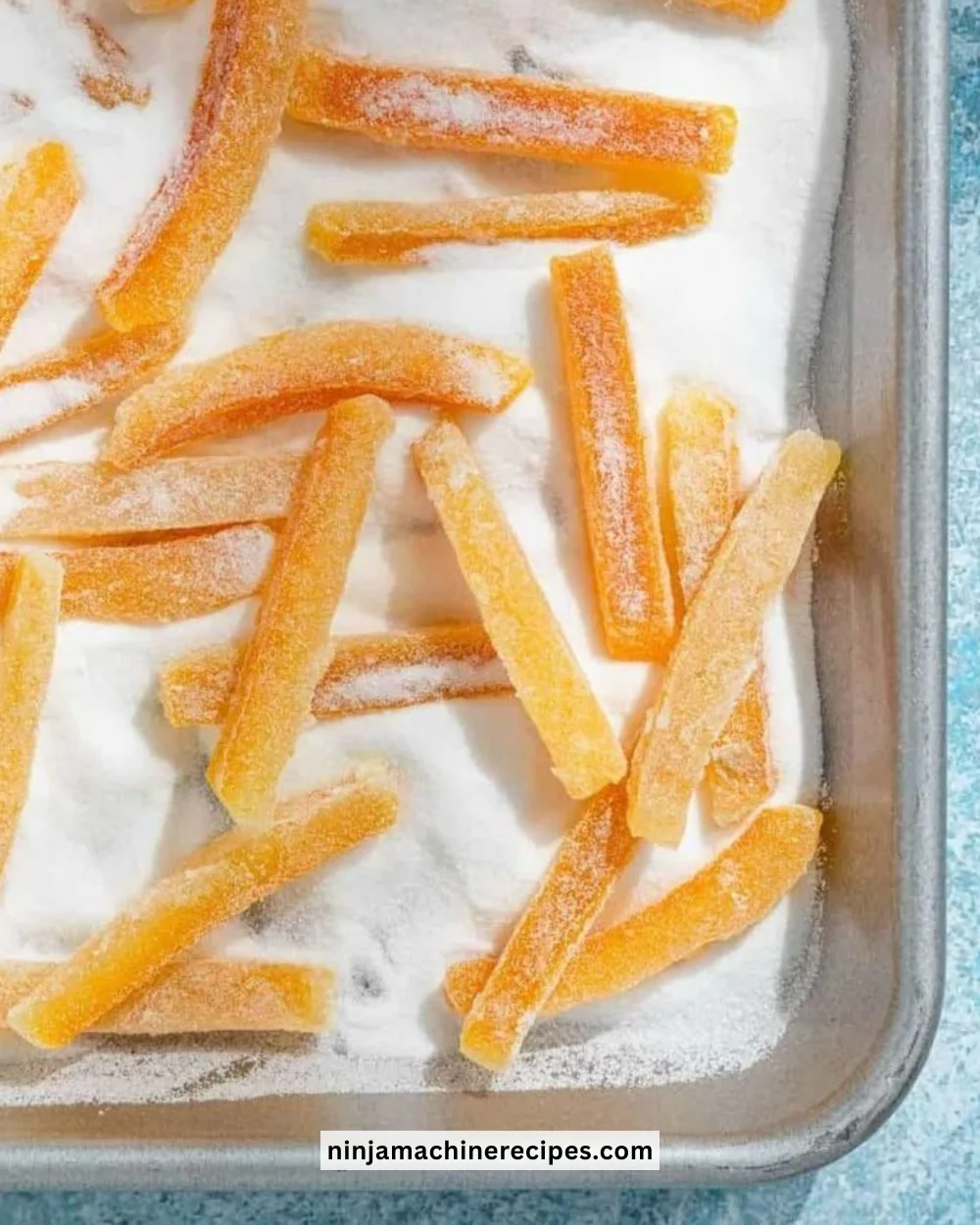 Homemade candied orange peel arranged on a decorative plate