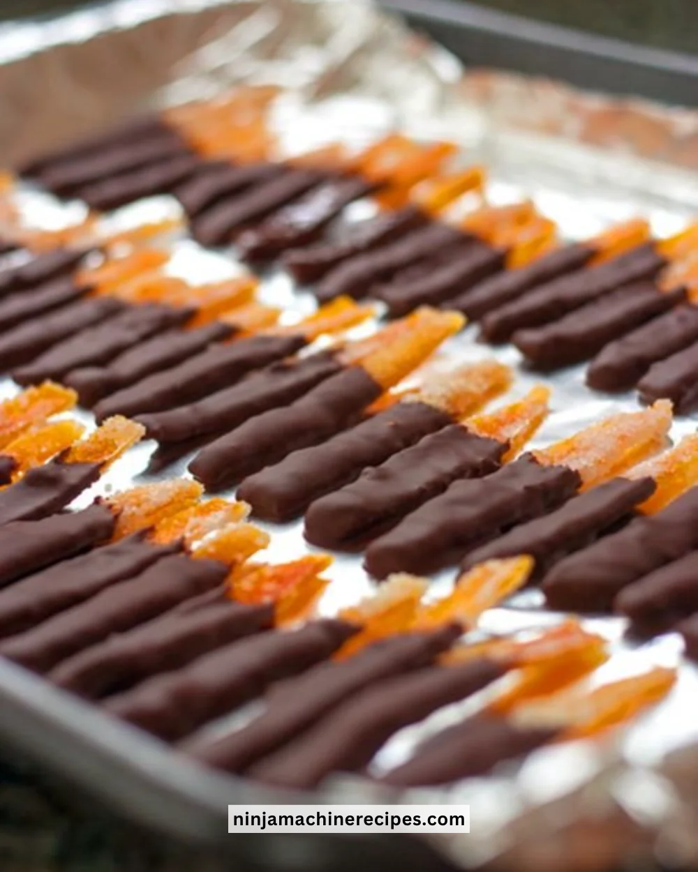 Delicious chocolate-covered orange peels on a white plate