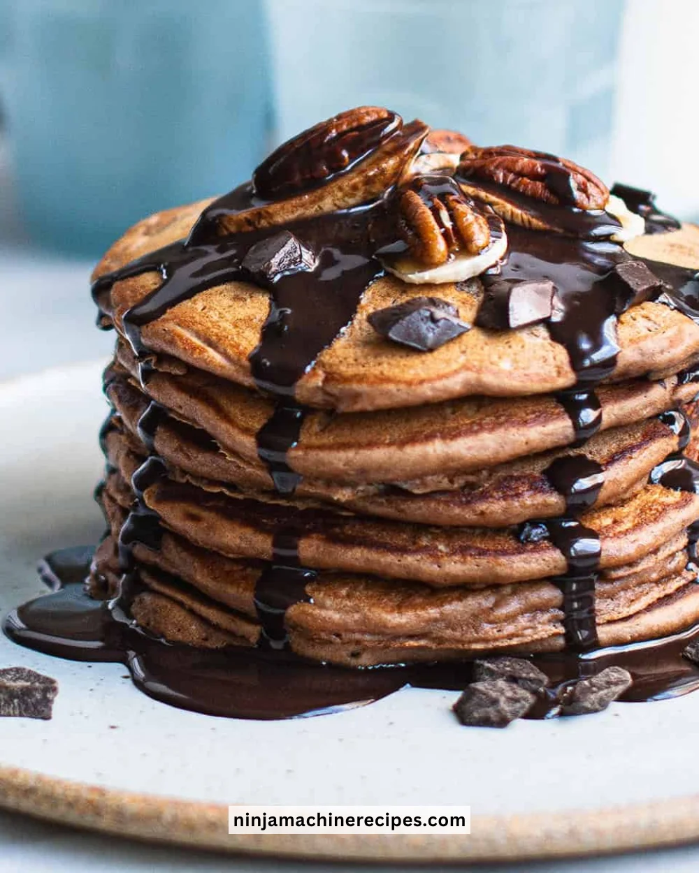 Delicious Chocolate Protein Pancakes topped with fresh fruit and syrup