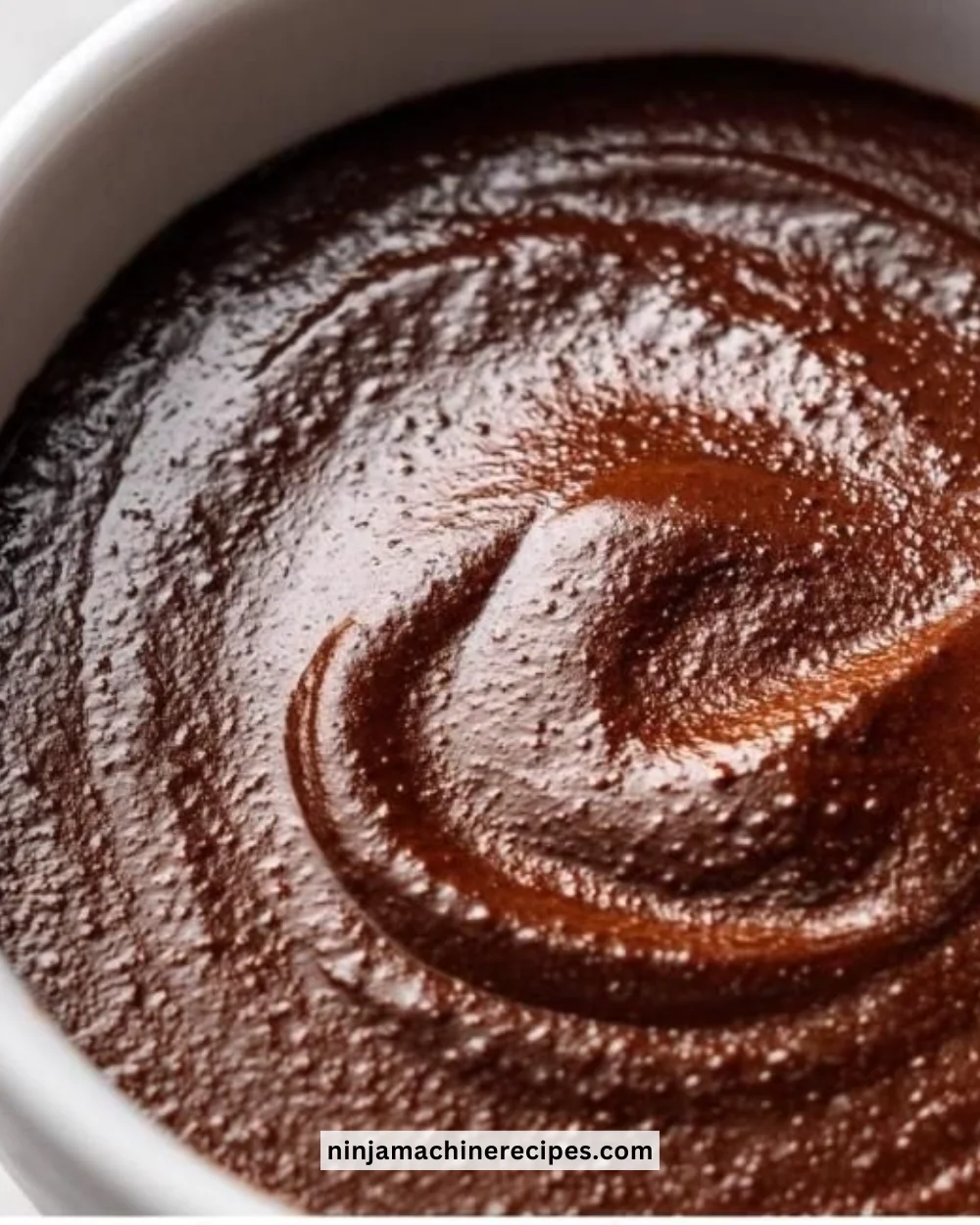 Delicious homemade chocolate pudding served in a bowl with chocolate shavings on top.