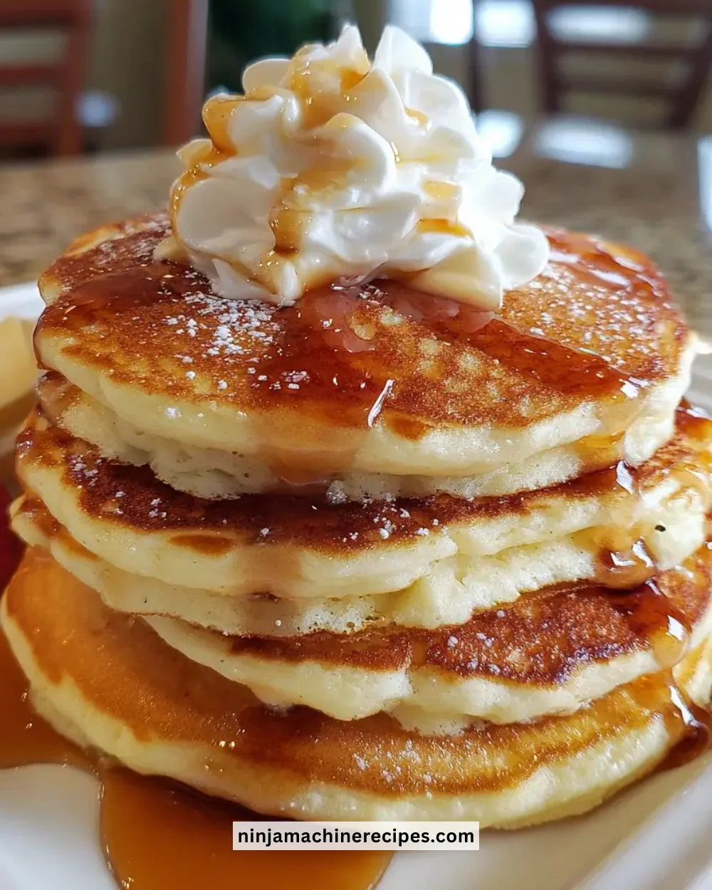 Stack of classic fluffy pancakes drizzled with syrup and topped with berries