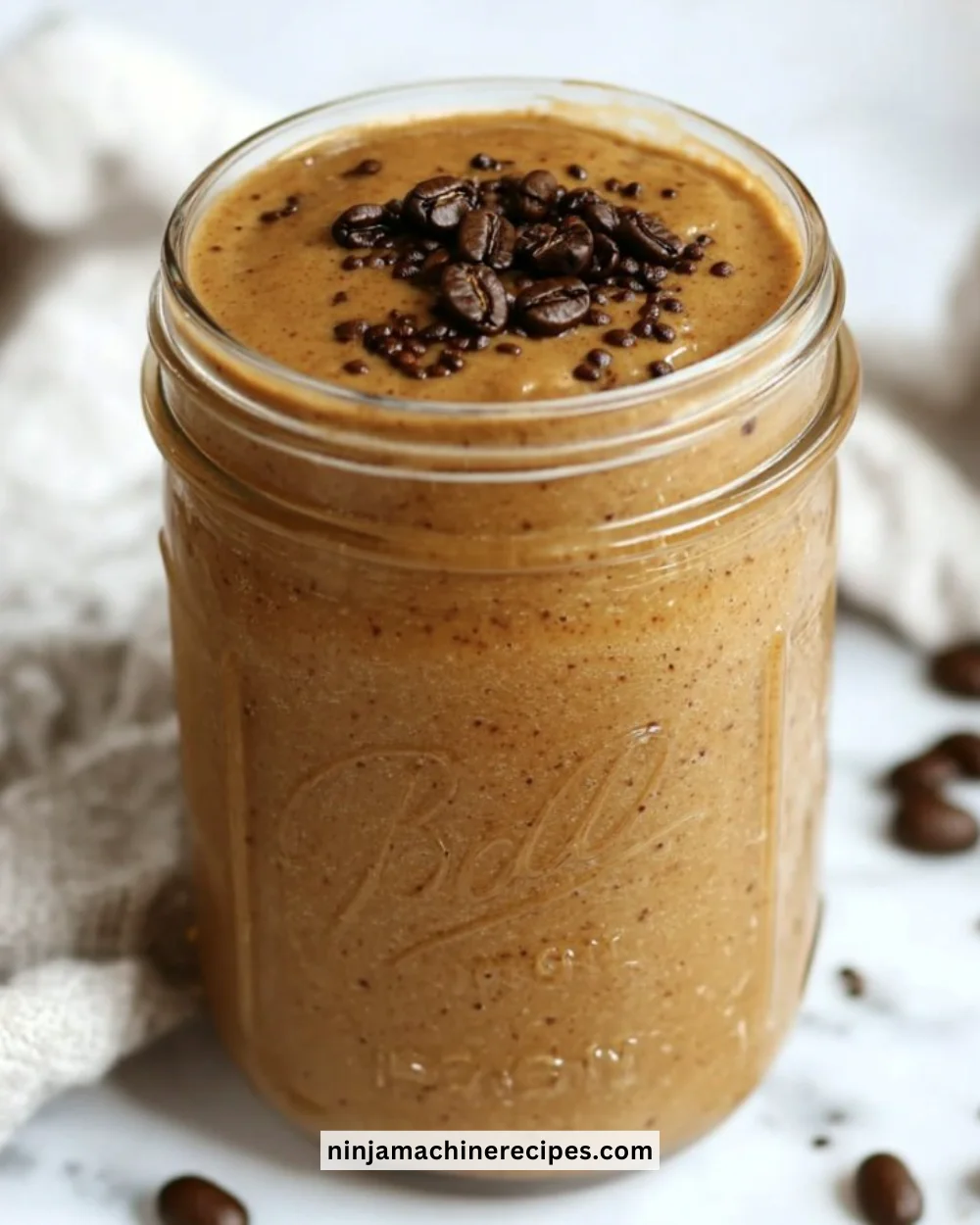 A refreshing coffee smoothie with a swirl of whipped cream and chocolate drizzle.