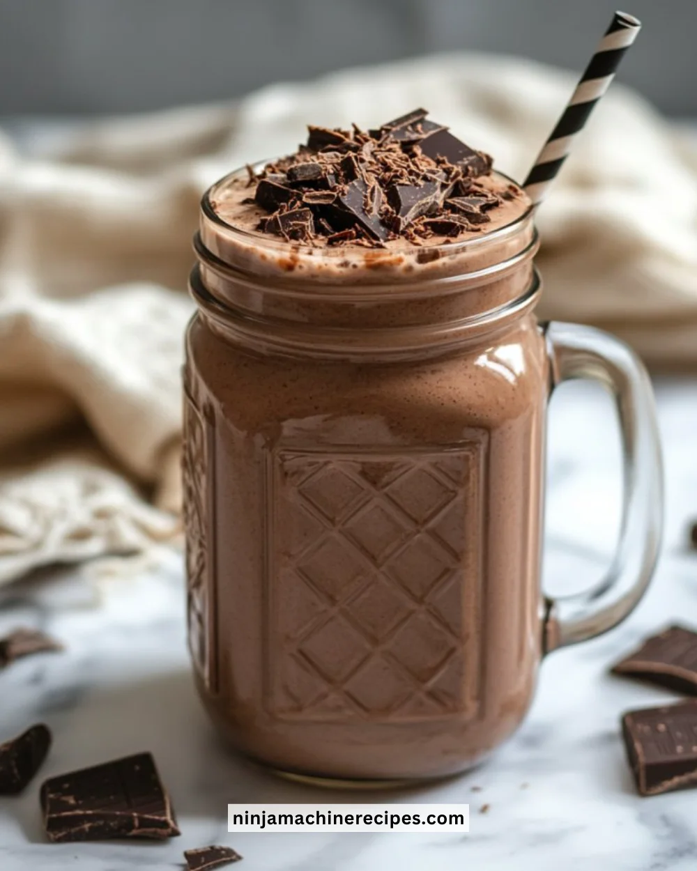 Delicious creamy chocolate smoothie in a glass with fresh ingredients