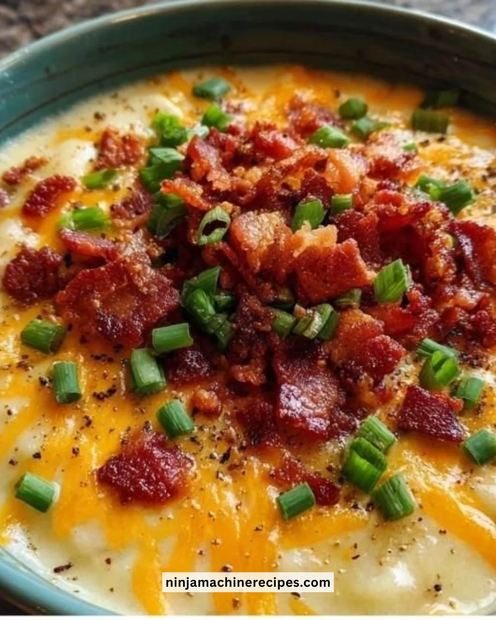 Bowl of creamy Crockpot Potato Soup garnished with green onions.