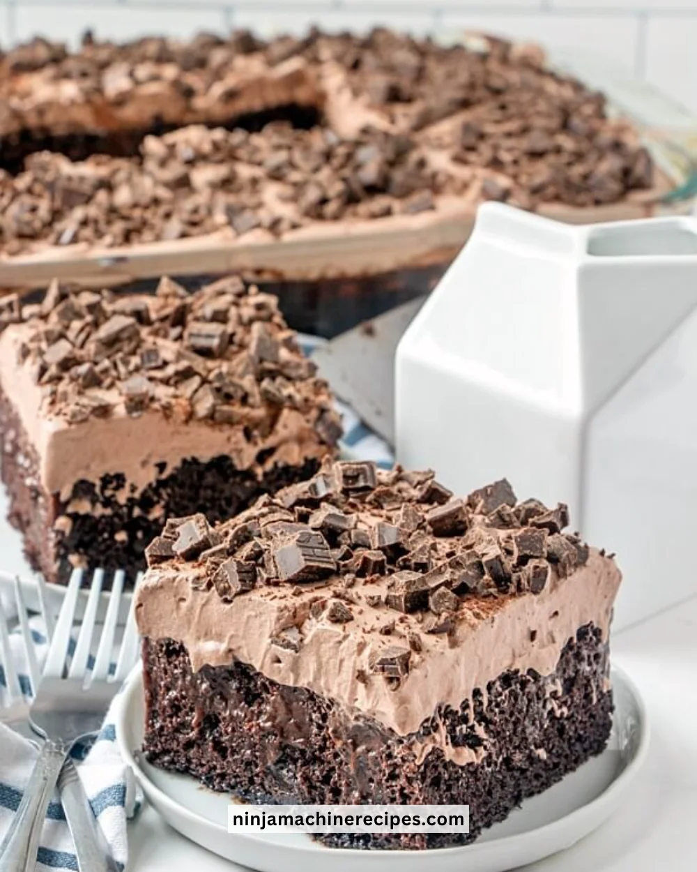 Decadent Death By Chocolate Poke Cake topped with chocolate frosting