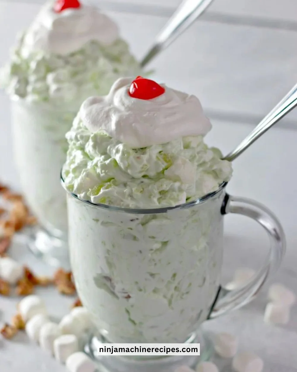 Bowl of Easy Watergate Salad topped with cherries and nuts