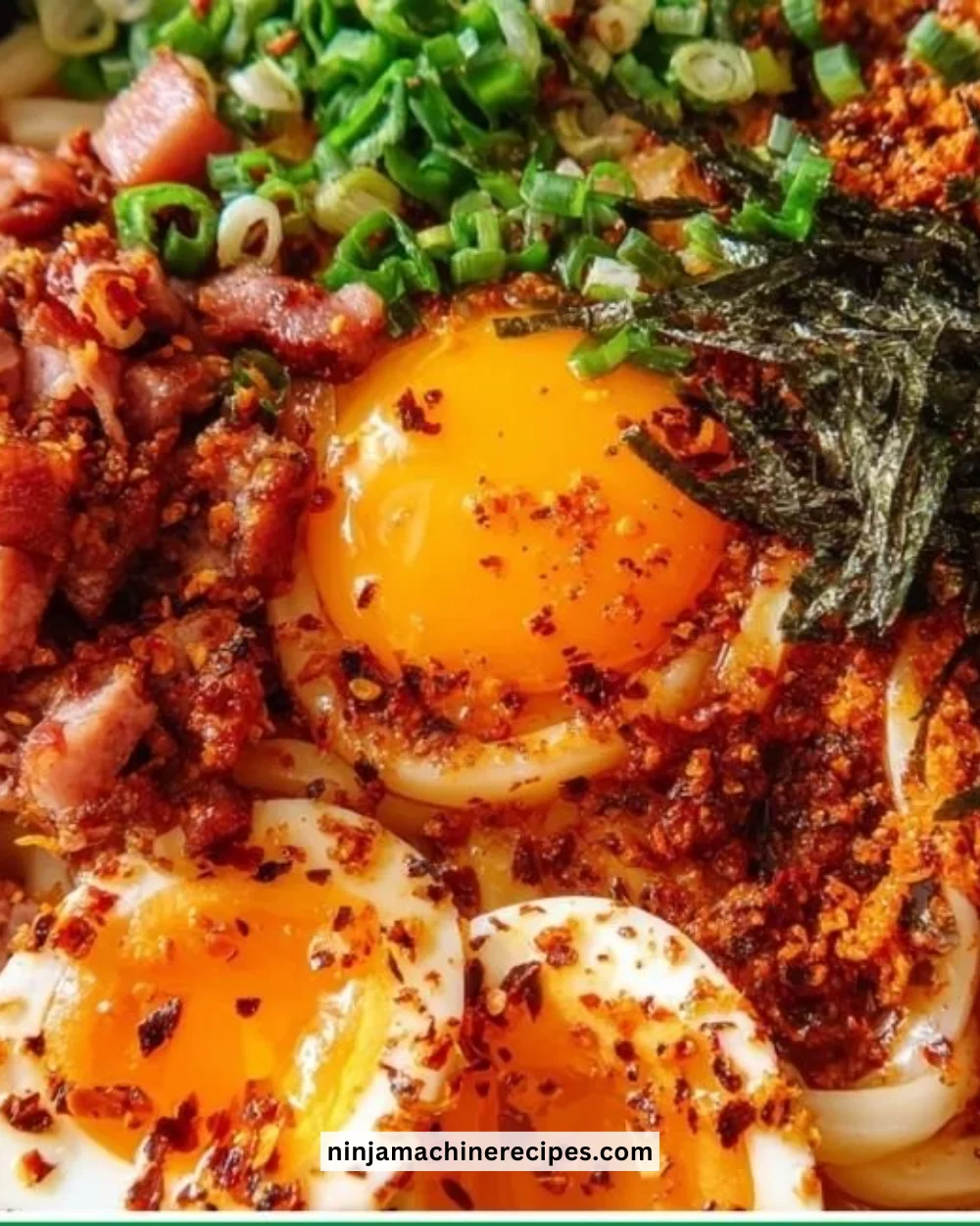 Bowl of Egg and Bacon Breakfast Udon topped with green onions