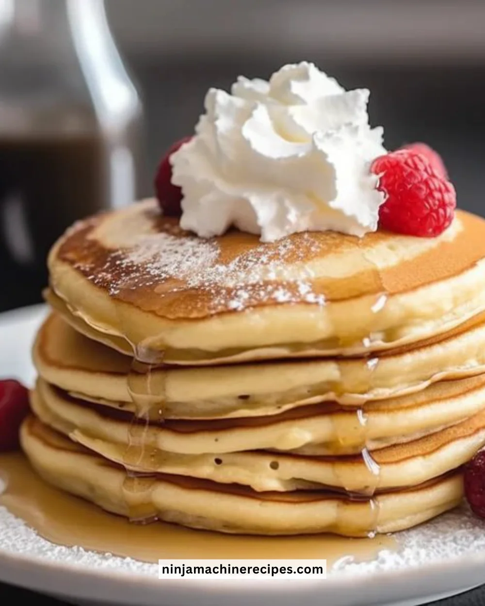 Stack of fluffy low-carb pancakes with berries and syrup