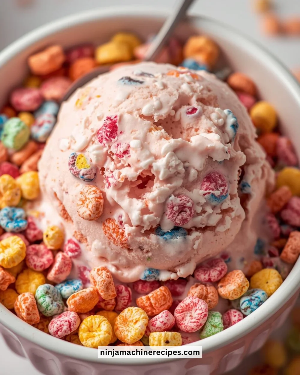 Fruity Pebbles Protein Ice Cream in a bowl with colorful cereal.