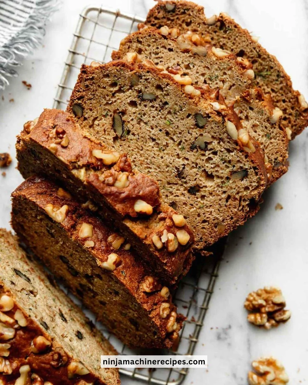 Homemade gluten-free zucchini bread loaf on a wooden table.