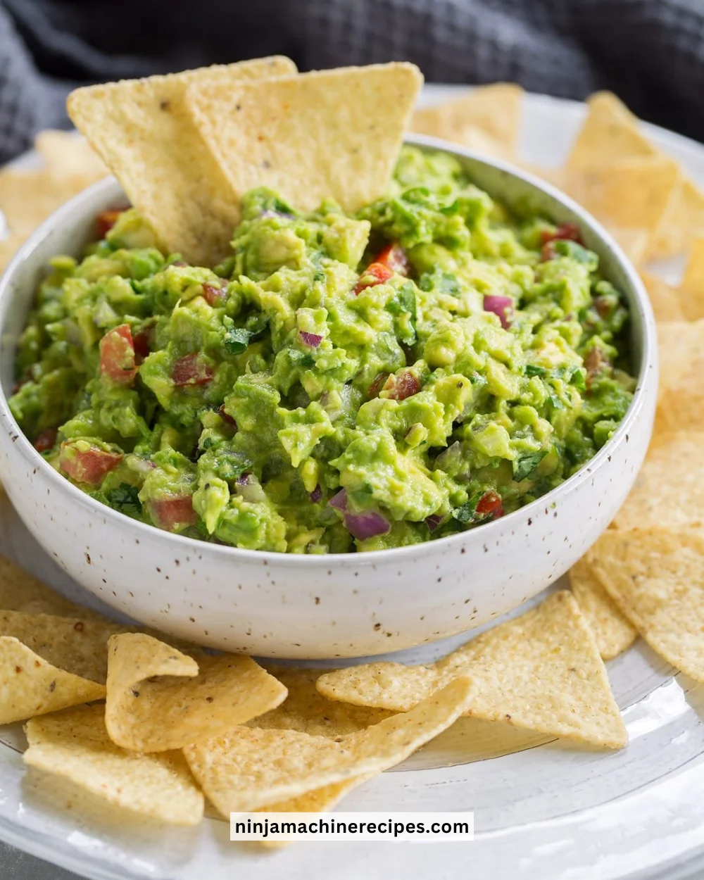 Fresh guacamole served with tortilla chips in a colorful bowl
