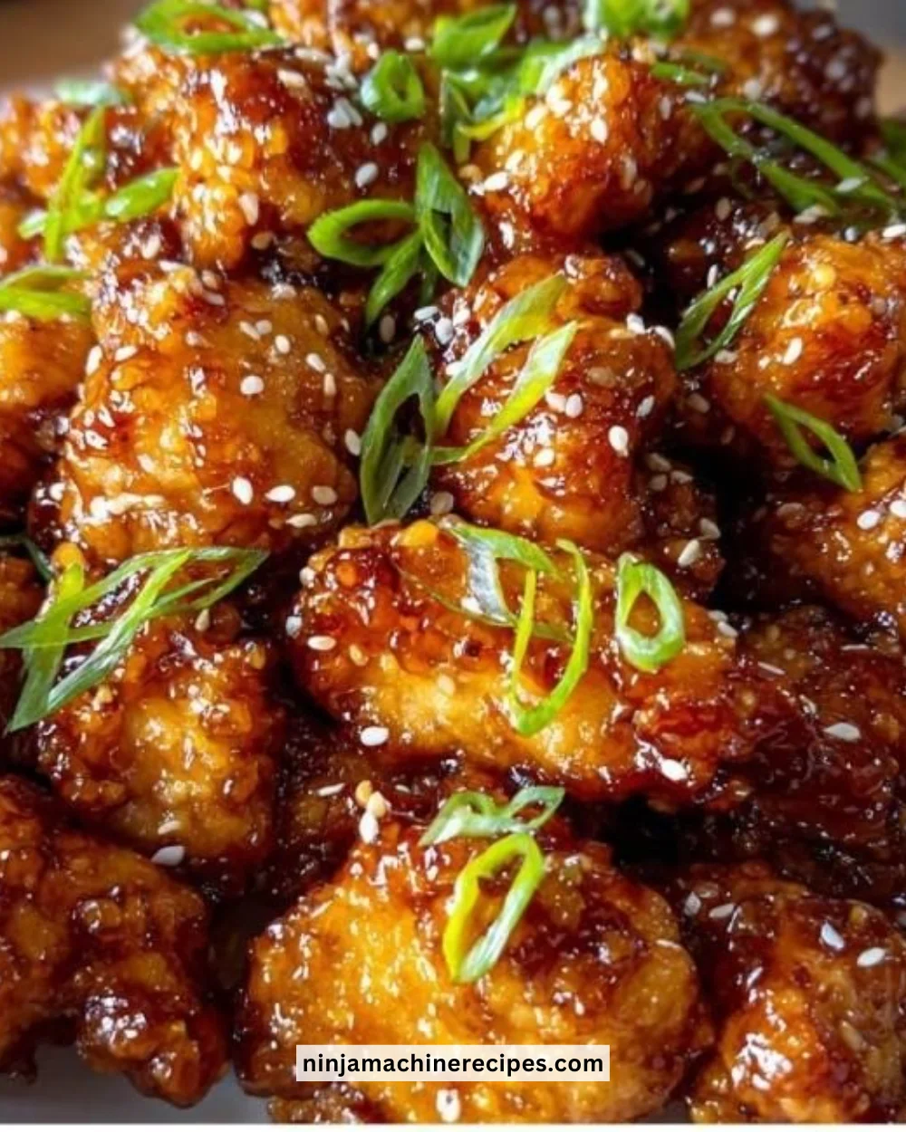 Plate of Honey Garlic Chicken garnished with green onions.
