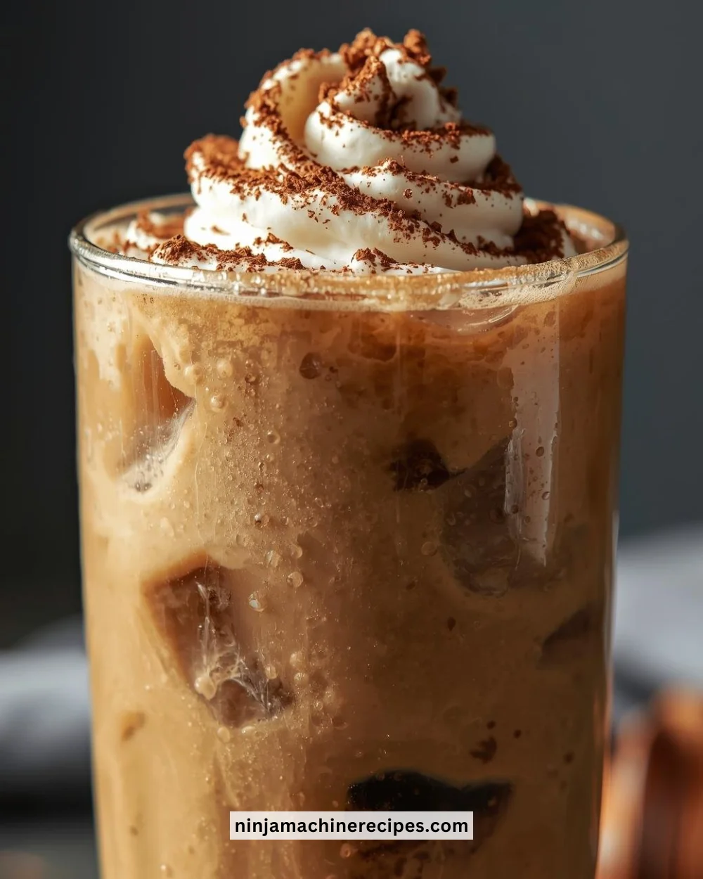 Iced coffee protein shake in a glass with ice and protein powder